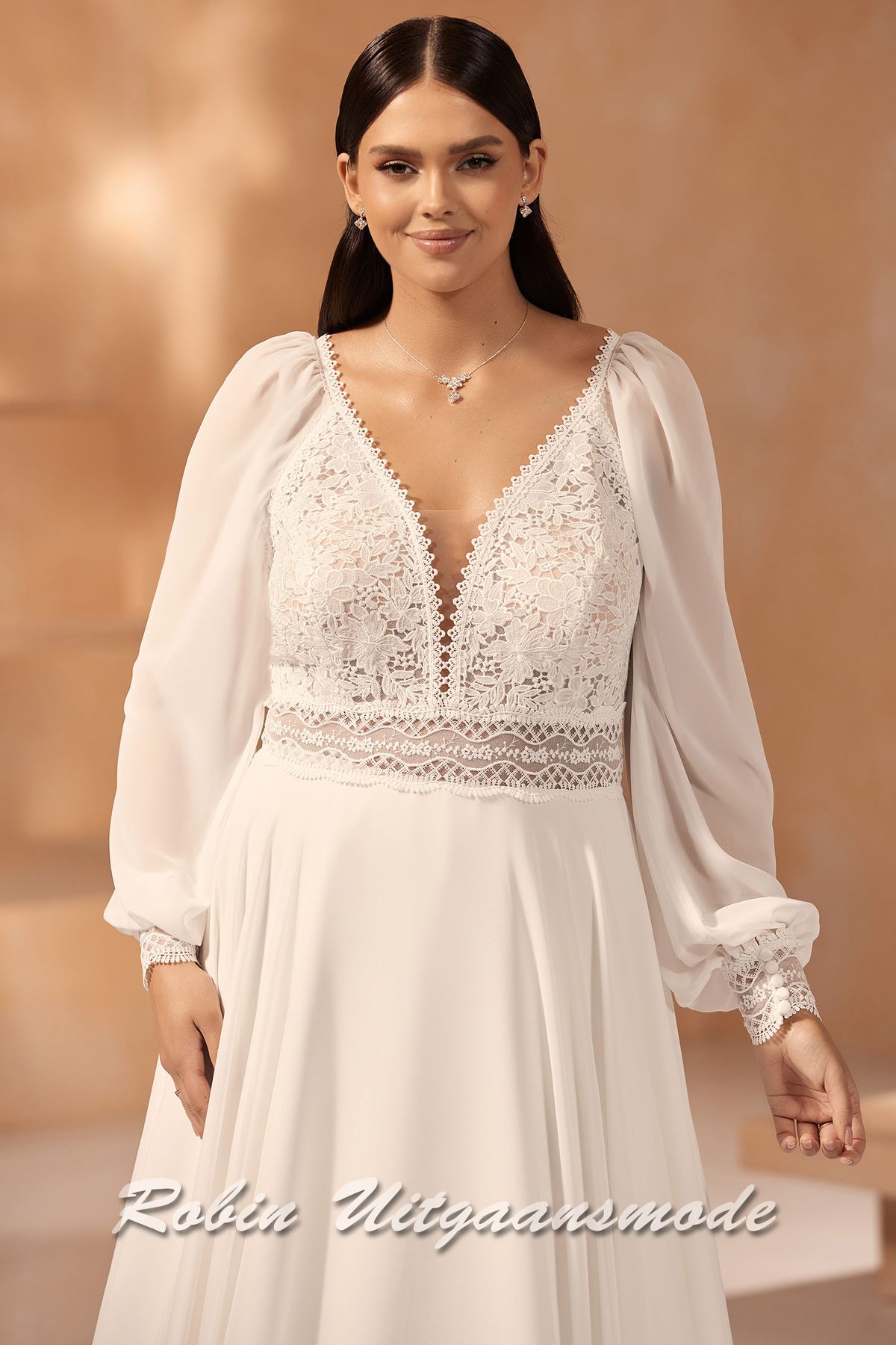 Close-up van de A-lijn plus size trouwjurk met kanten lijfje en lange mouwen