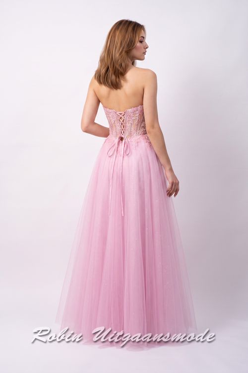 Achterkant van de Lichtroze galajurk strapless korset lijfje, fleurige bloemversiering over de top en  A-lijn tule rok met hoge split