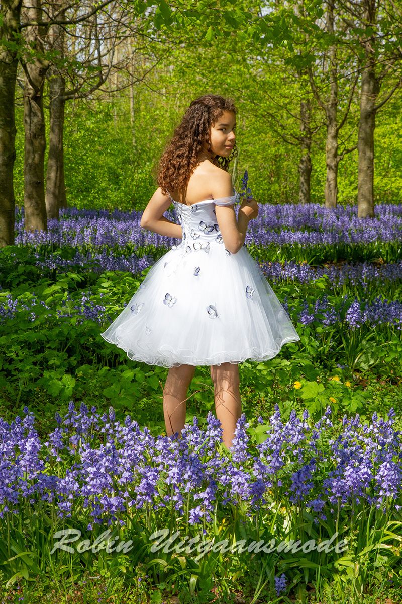 Achterzijde van de Feestelijke jurkje van vrolijke vlinderstof, met strapless lijfje, afhangende schouders en wijde tule rok.