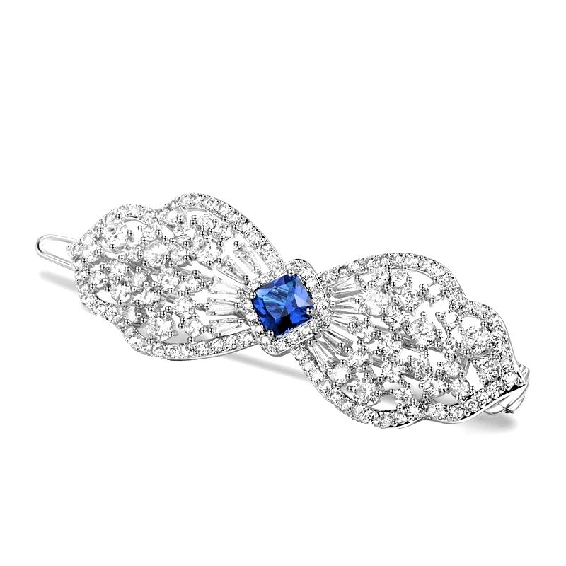 Extravagante haarclip in strikvorm met saffierblauw kristal