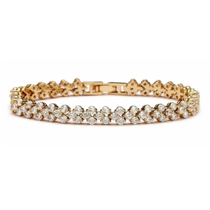 Goudkleurige armband met driedubbele rij strass stenen